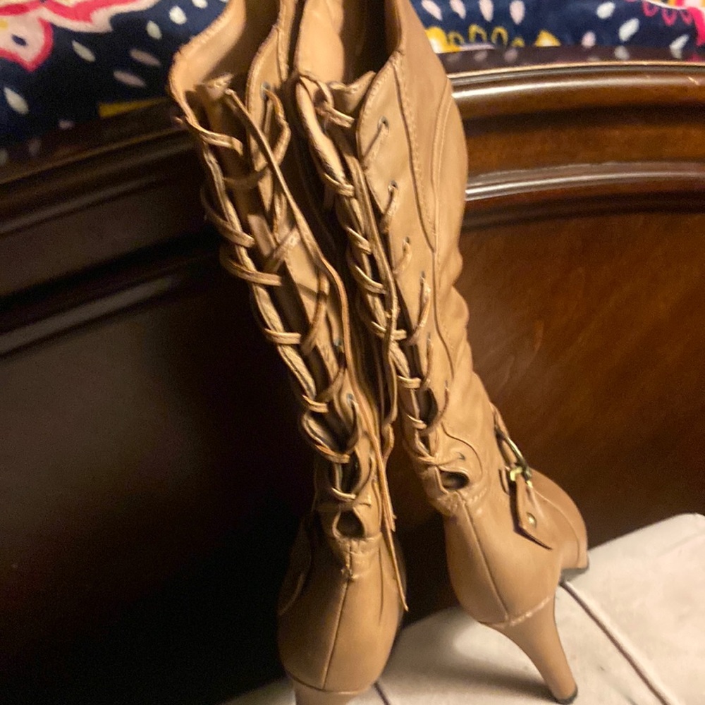 Heals boots that lace up in the back.